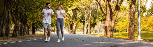 Two people walking together & talking for fitness & friendship